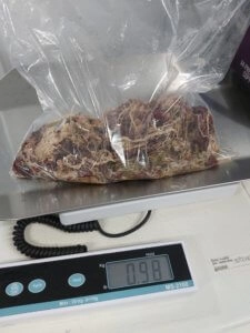 Hollie blanket sample sealed in a plastic bag placed on a digital weighing scale showing measurement