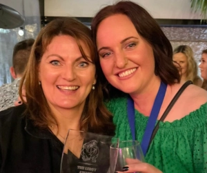 Lynn and Mich smiling together while holding drinks during the Berwick Veterinary Hospital Christmas party awards night celebration